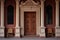 front door framed by intricate corbels of an italianate mansion