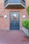 Front door of a house with ornate glass panel and red brick walls in San Francisco, California