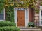 front door of house surrounded by vines