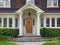 Front door of large suburban house with gabled portico