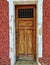 Front door of an old house in a neighborhood of Sao Paulo. Entrance gate of an ancient house in Sao Paulo city, Brazil. Red wall.