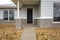 The front door and porch of a brand new timber weatherboard house. A classic Australian-style home. Concept of real estate