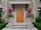 Front door of stone house with large flower pots