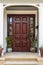 Front door, view of front door accented with plants