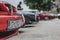 Front end and license plate of an Alfa Romeo 155, parked in a row with multiple other Alfa Romeos, part of an exhibition