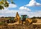 Front end loader with backhoe in action