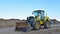 Front-end loader working at construction site. Earth-moving heavy equipment for road work. Public works, civil engineering, road