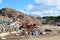 Front-end loader works in a landfill for the disposal of construction waste and other debris. Industrial waste treatment