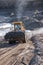 Front-end wheel loader and bulldozers in operation.