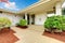 Front exterior entrance to white and beige home with double door