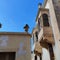 Front facade of an ancient building with balconies in Mdina, Malta