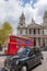 Front facade with bus and taxi passing in front of St Paul s cathedral.