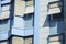 Front facade of a contemporary blue office building with windows