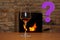 In front of the fireplace, in which firewood burns with a bright flame, there is one glass of wine, a question mark
