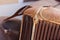 Front grill of an old rusty motor car in a scrap yard