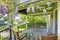 Front house porch with chairs and flowers.