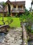 In front of the house there is a fish pond and a bridge stands