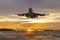 Front image commercial passenger aircraft or cargo airplane fly over coast of sea in evening with golden sunset seascape view and