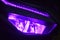 The front LED light of a purple automatic motorbike