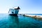 Front loading ferry boat moored with lifted bow at pier.