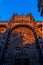 The front of the new cathedral of Salamanca with bas-reliefs of religious motifs, from a low angle view, illuminated by the golden