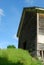 Front of old wood barn reaching up into a blue summer sky