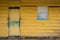 Front of old wooden house - yellow, vintage wooden hut