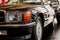 Front part of classical black automobile parked indoor at car show