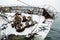 Front part of a fishing ship sunken a pier in winter