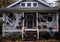 Front porch of a bungalow house has been decorated with spiders Halloween