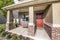 Front porch exterior with red orange door and res bricks siding