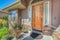 Front porch of house with wooden door and garden