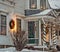 Front porch of White New England clapboard house fully decorated to welcome the holiday season