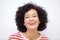 Front portrait of and older african american woman laughing against white background