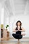 Front portrait of woman practicing yoga, balancing on one leg. Meditation, relaxing. Healthy body and spirit. Copy space