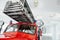 Front of the red polished fire truck standing indoor at exhibition