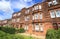 Front of red stone tenement buildings