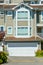 Front of residential townhouse with asphalt driveway on sunny day