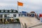 The front of a ship with a orange flag, Docked boat in the harbor, transport and travel background