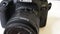 A front shot of a heavily used Canon SLR camera, model 77D - tracking shot