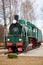 Front side view of classic old green soviet steam locomotive with red star