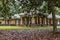 A front side view of an updated spacious red brick ranch traditional house home with off white columns and brick front steps with