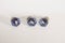 Front of three very small blue glass drawer knobs or pulls