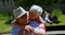 Front view of active Caucasian senior couple embracing each other in the garden of nursing home 4k