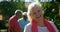 Front view of active Caucasian senior woman smiling in the garden of nursing home 4k