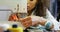 Front view of African American female fashion designer working with sewing machine in workshop 4k