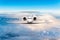 Front view of aircraft. Privat jet in flight. The passenger plane flies high above the clouds and blue sky. Luxury