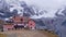 Front view of alpine refuge with Ortler mountain range and glacier in background. Text: Name of the shelter.