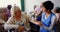 Front view of Asian female doctor interacting with senior woman at nursing home 4k