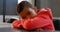 Front view of Asian schoolboy leaning over the desk in classroom at school 4k